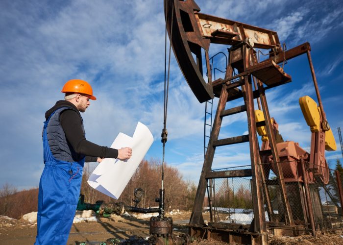 oil man controlling work of pump jack.